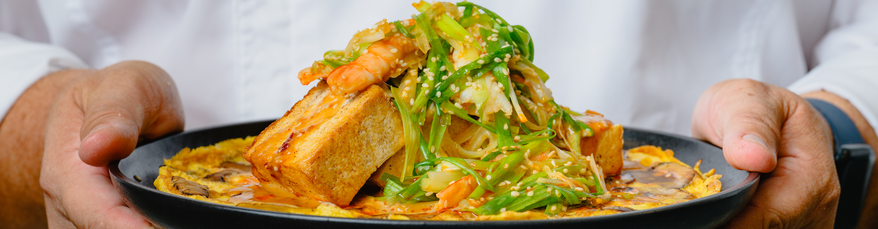 chef holding dish of food